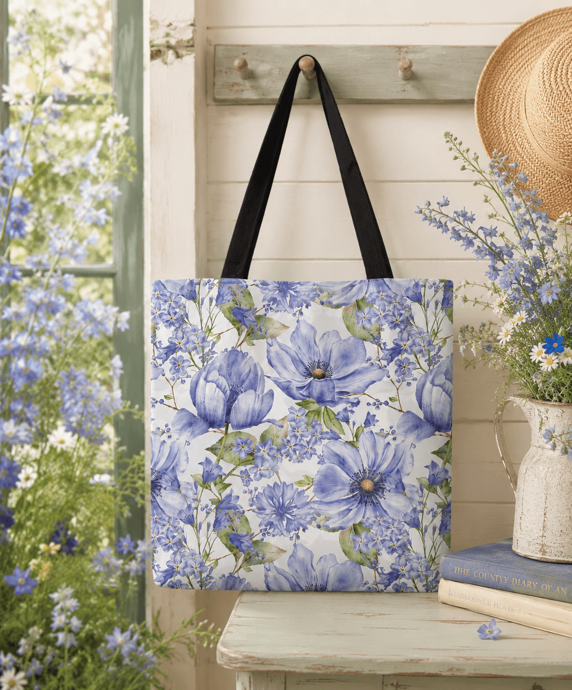 White and blue tote bag with an all-over hand-painted pattern of blue anemones and cornflowers