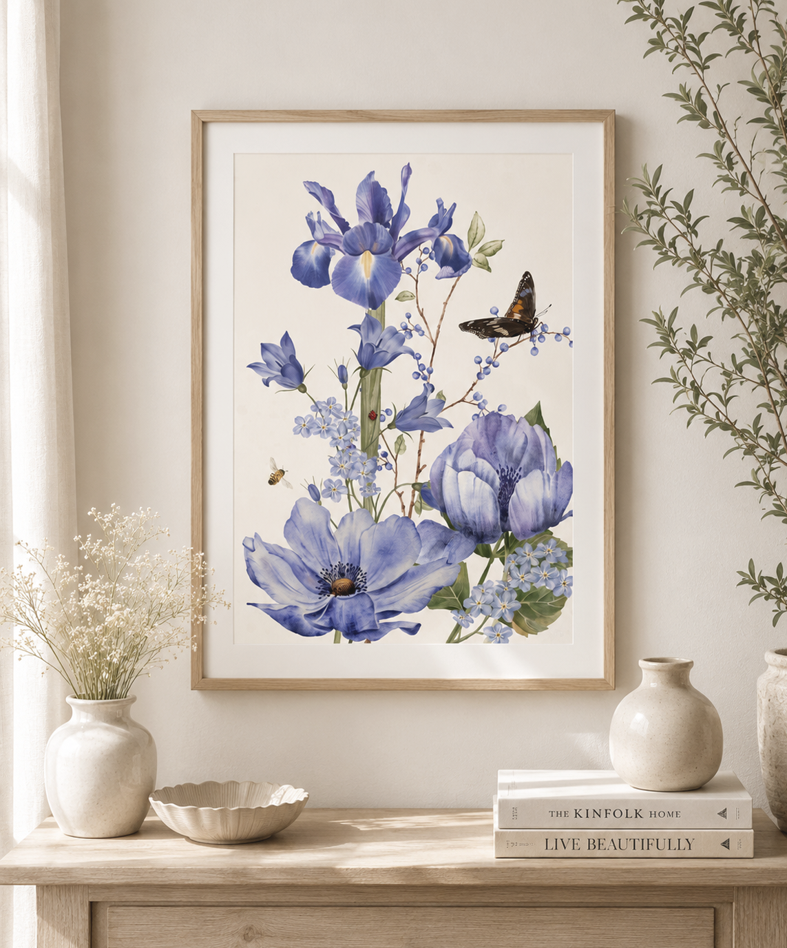 Framed blue iris and wildflower watercolour art print by Gabrielle Marlow displayed on a console table