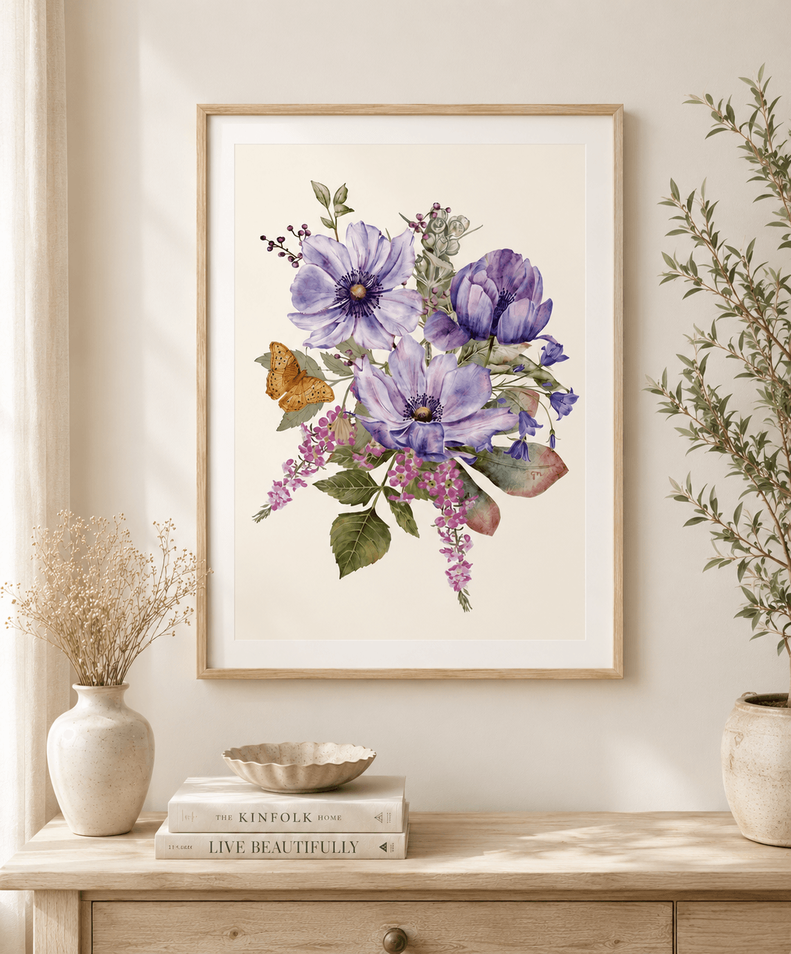 Framed purple anemone watercolour botanical art print with butterfly, hanging above a console table