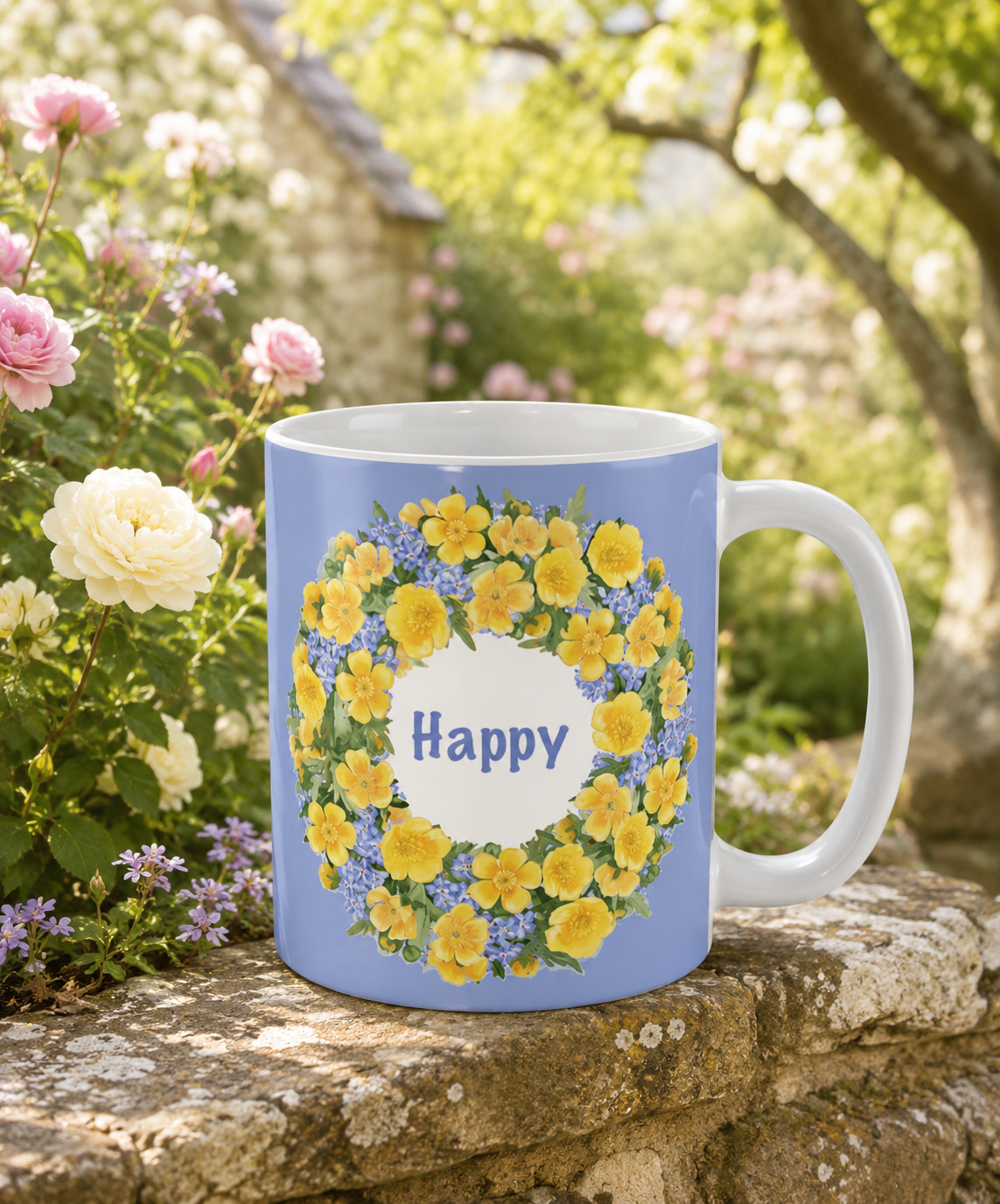 Blue ceramic mug with a yellow buttercup wreath and "Happy" wording, sitting on a garden stone wall