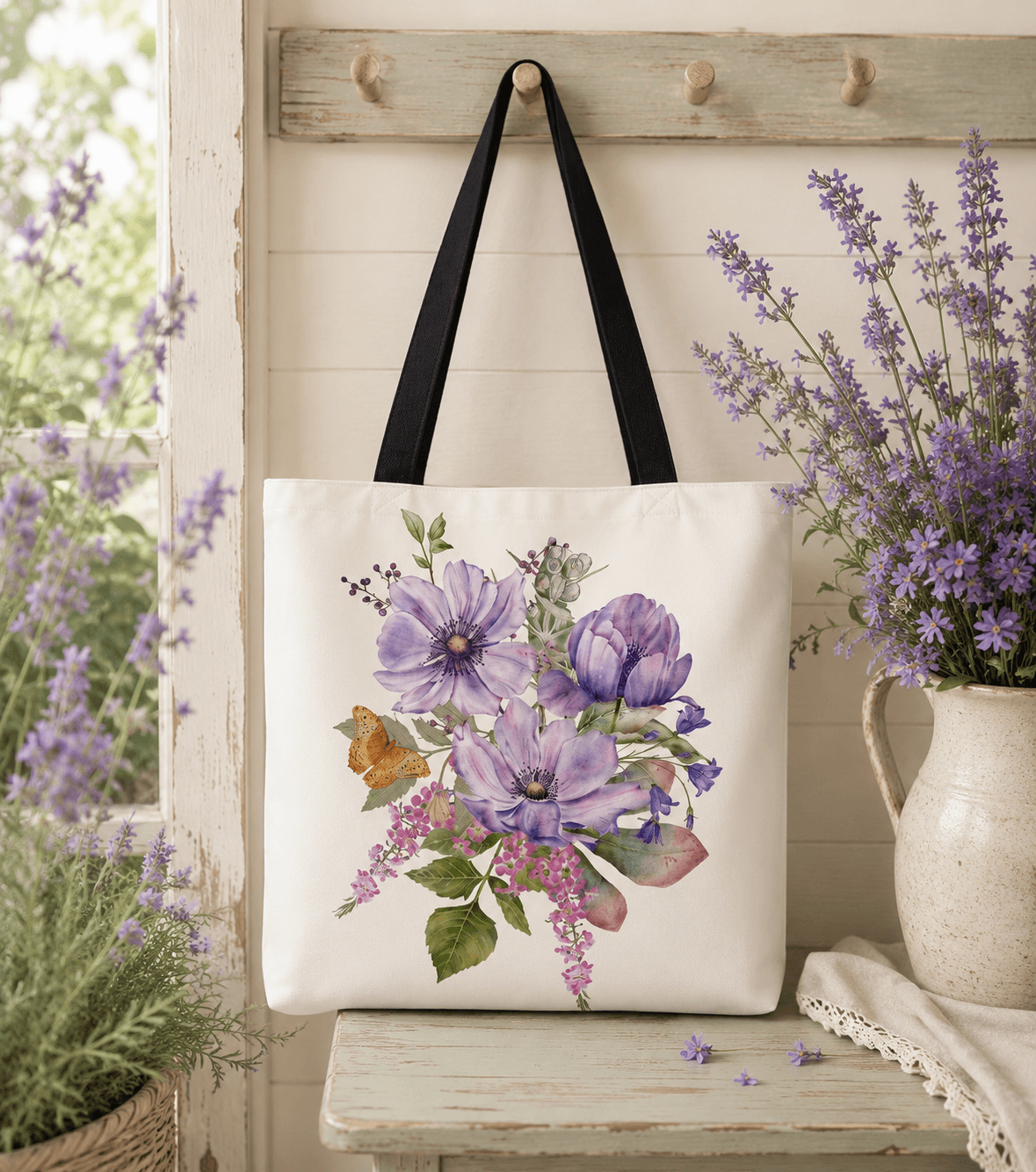 Cream tote bag with a hand-painted bouquet of purple anemones, bluebells, and a butterfly
