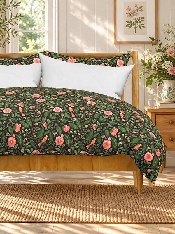 Duvet cover printed with a large-scale Indian chintz tree of life in watercolour, with pink ruffled blooms, round berries and two perched birds on navy